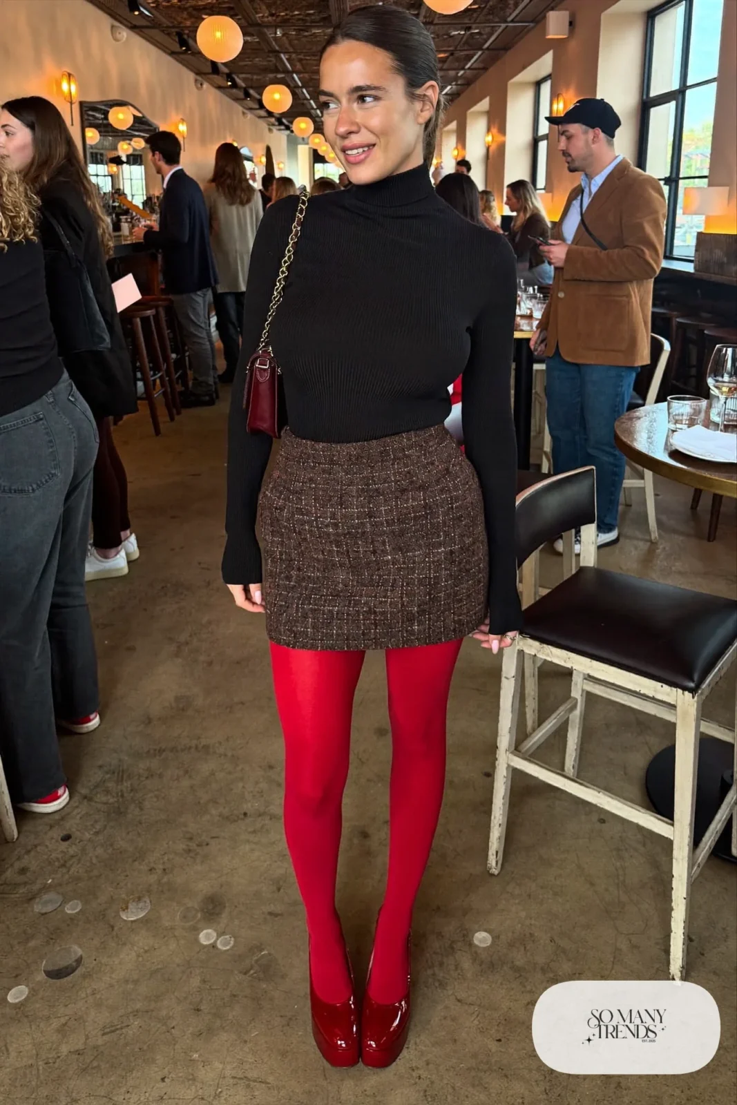 Woman in a chocolate tweed mini skirt, black turtleneck and cherry red platform pumps, outfit 15