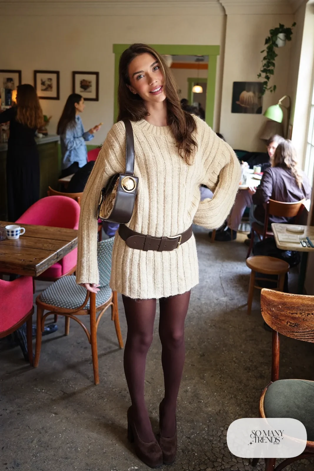 Woman in a loose cream knit mini dress, wide brown belt and chocolate platform pumps, outfit 18