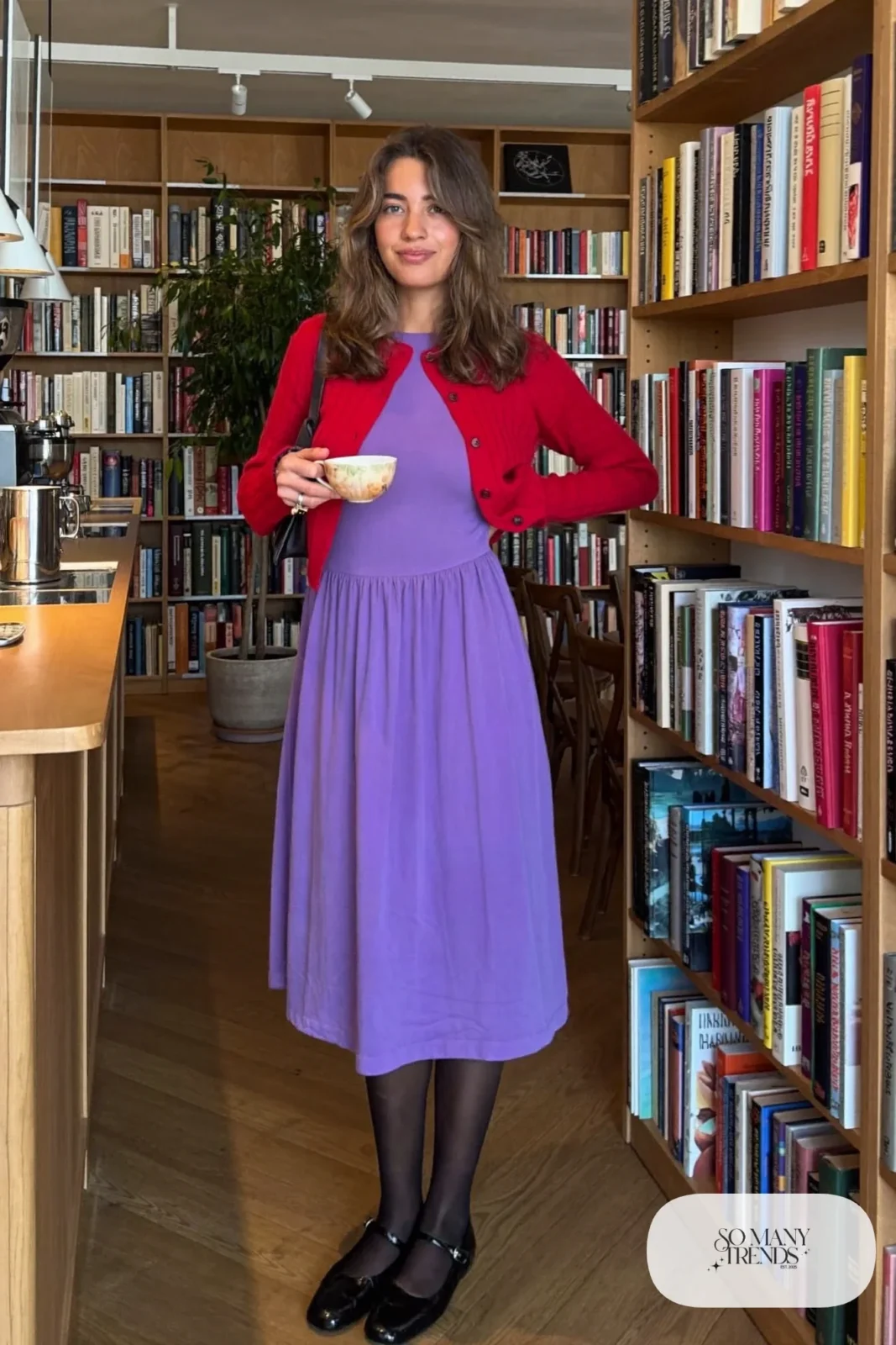 Woman in a violet jersey midi dress, short cherry red cardigan and black mary janes, look 4