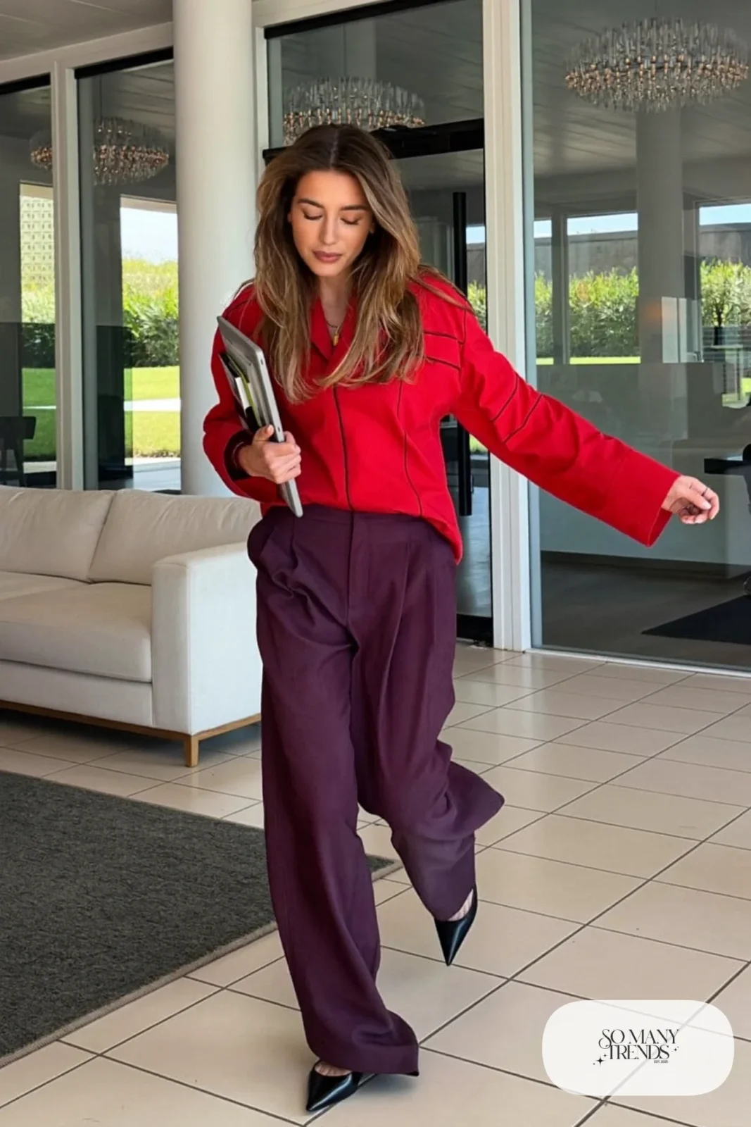 Woman in a red blouse, eggplant wide-leg pants and black pointed flats, look 8