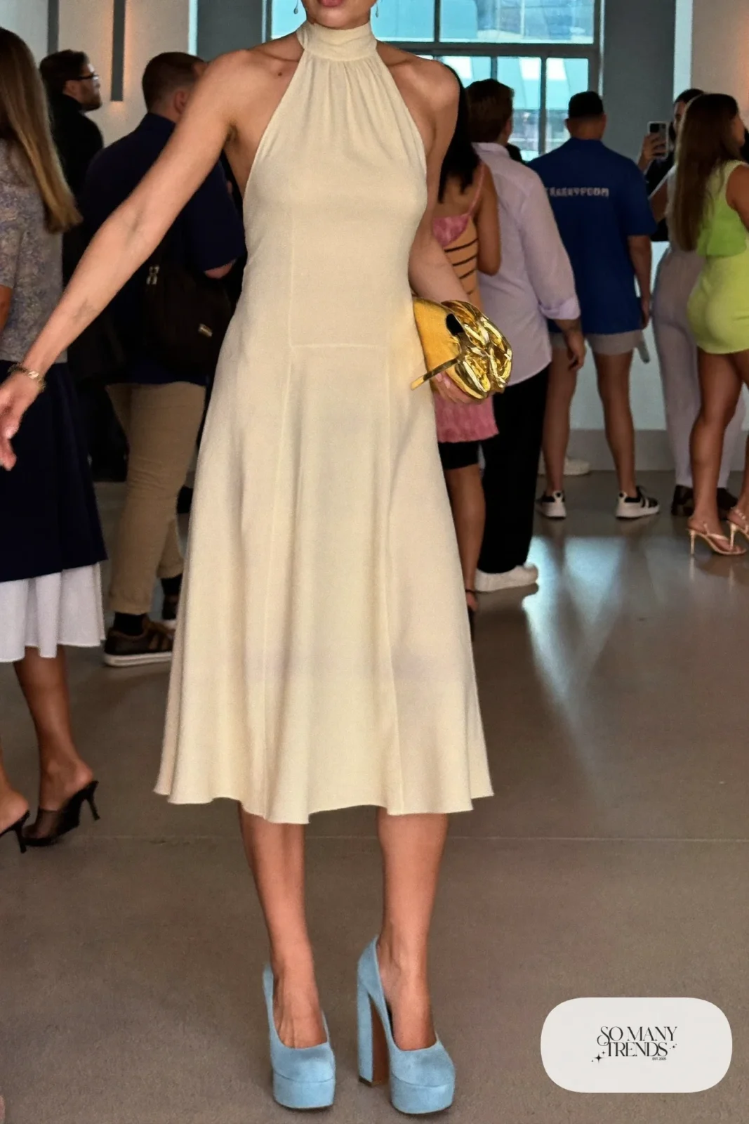 Woman in a cream crepe halter midi dress with powder blue platform pumps, outfit 5