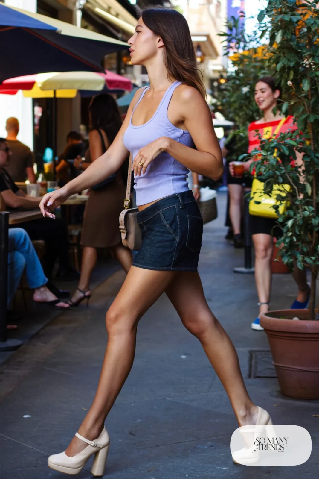 Woman in a dark denim mini skirt, lilac ribbed tank and cream platform pumps, outfit 14