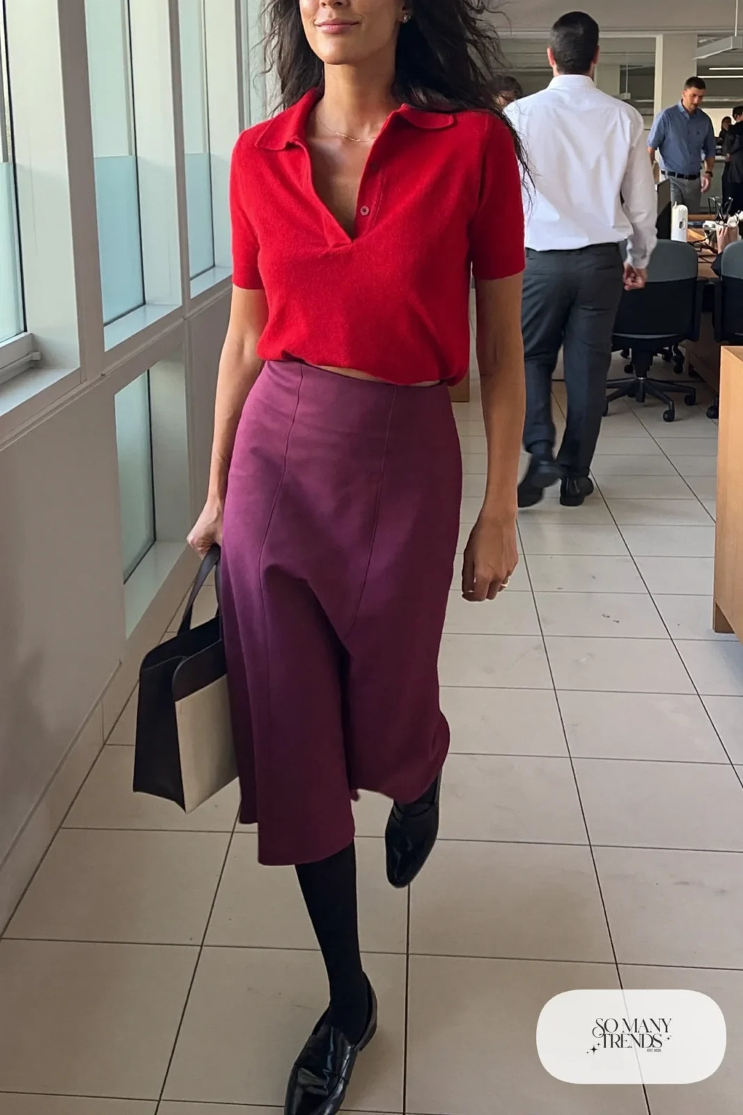 Woman in a cherry red polo knit top, plum A-line midi skirt and black loafers, look 15
