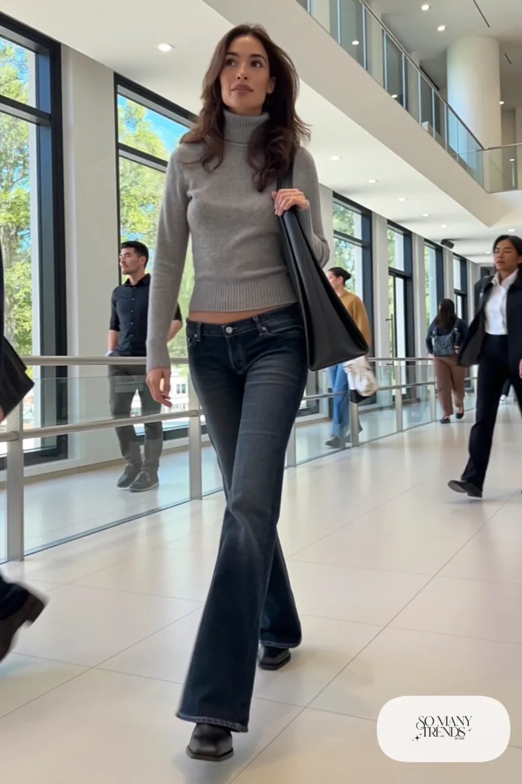 Woman in a fitted gray merino turtleneck, low-rise dark denim flare jeans and black square-toe boots, look 10
