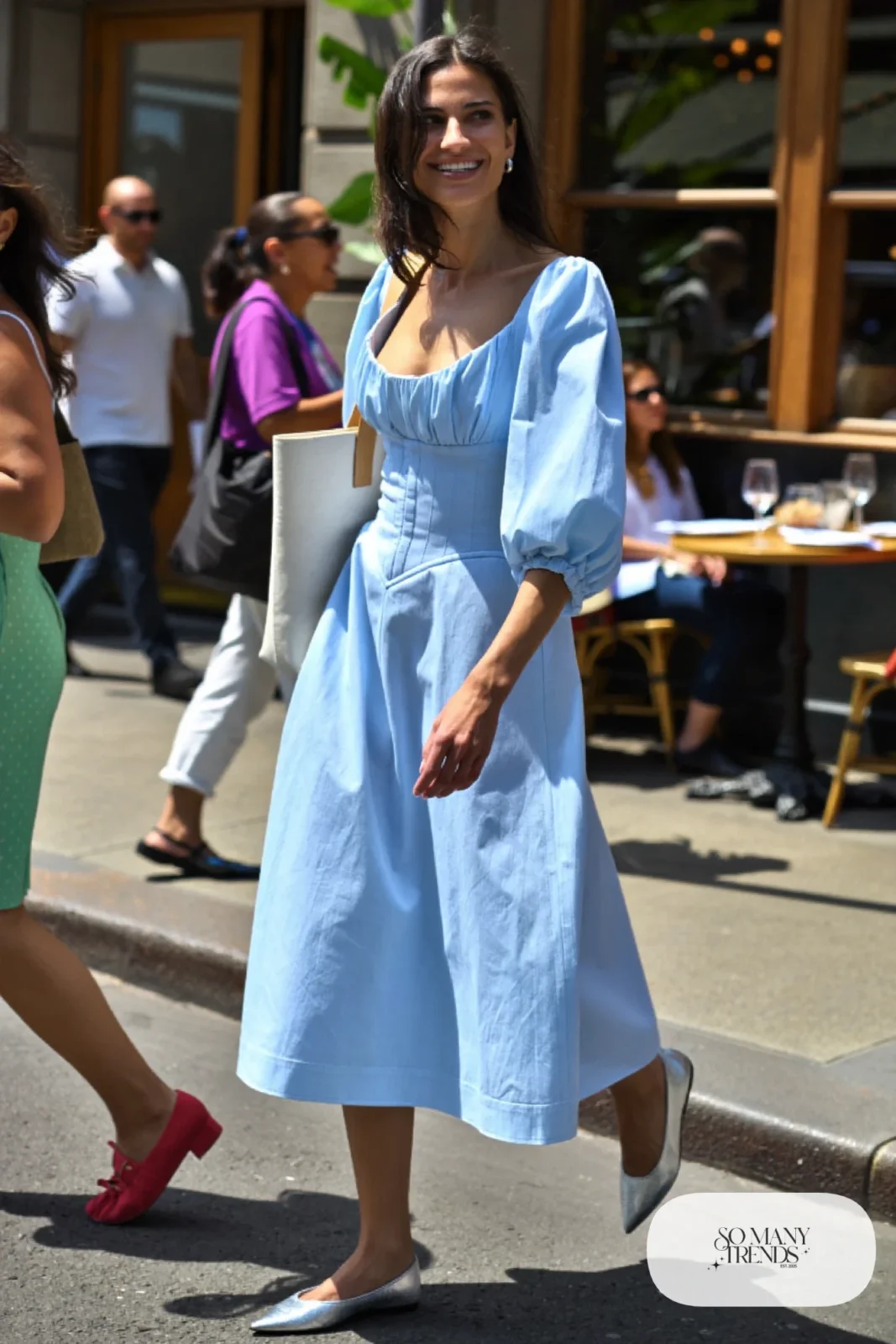 Woman in a pale blue poplin corset midi dress with full sleeves and pointed flats, outfit 3