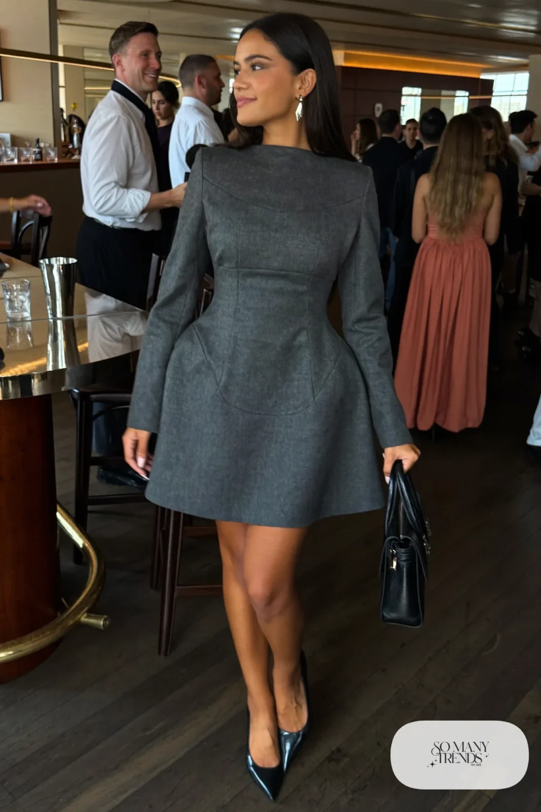 Woman in a slate gray wool-blend corset dress with fitted sleeves and black pumps, outfit 11