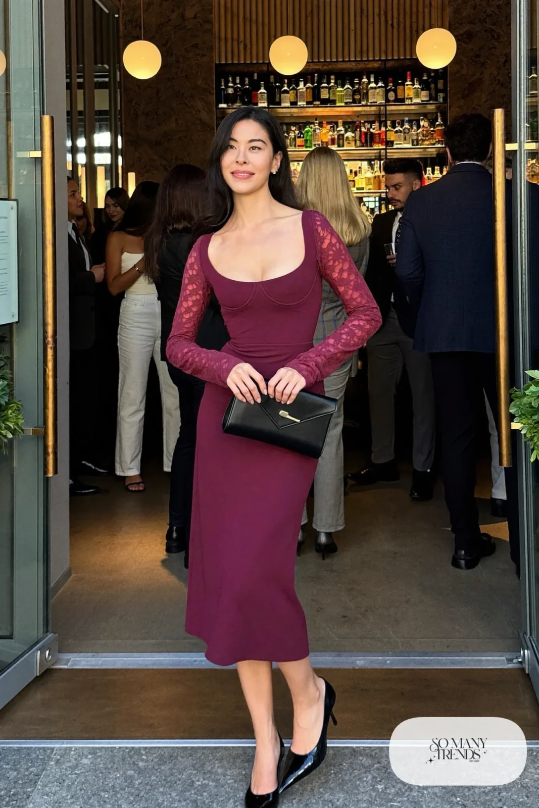 Woman in a plum corset midi dress with lace sleeves and pointed pumps, outfit 21