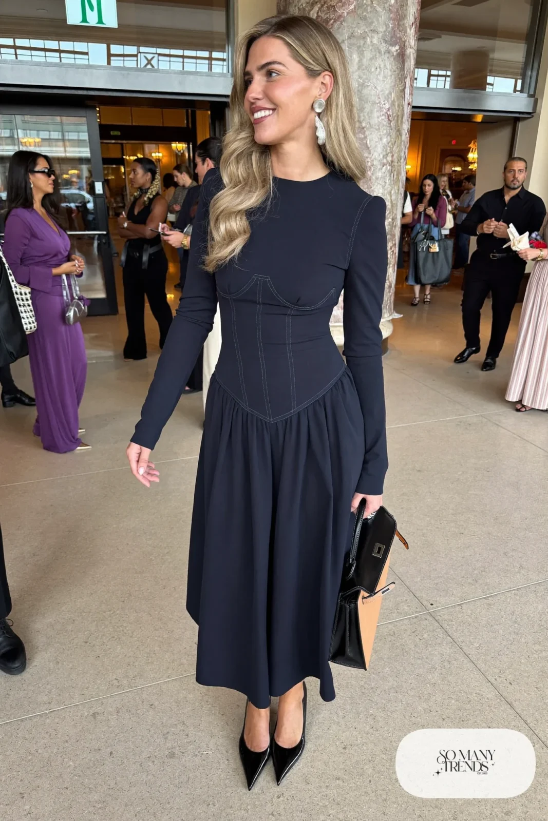 Woman in a navy wool crepe corset midi dress with long sleeves and silver jewelry, outfit 22