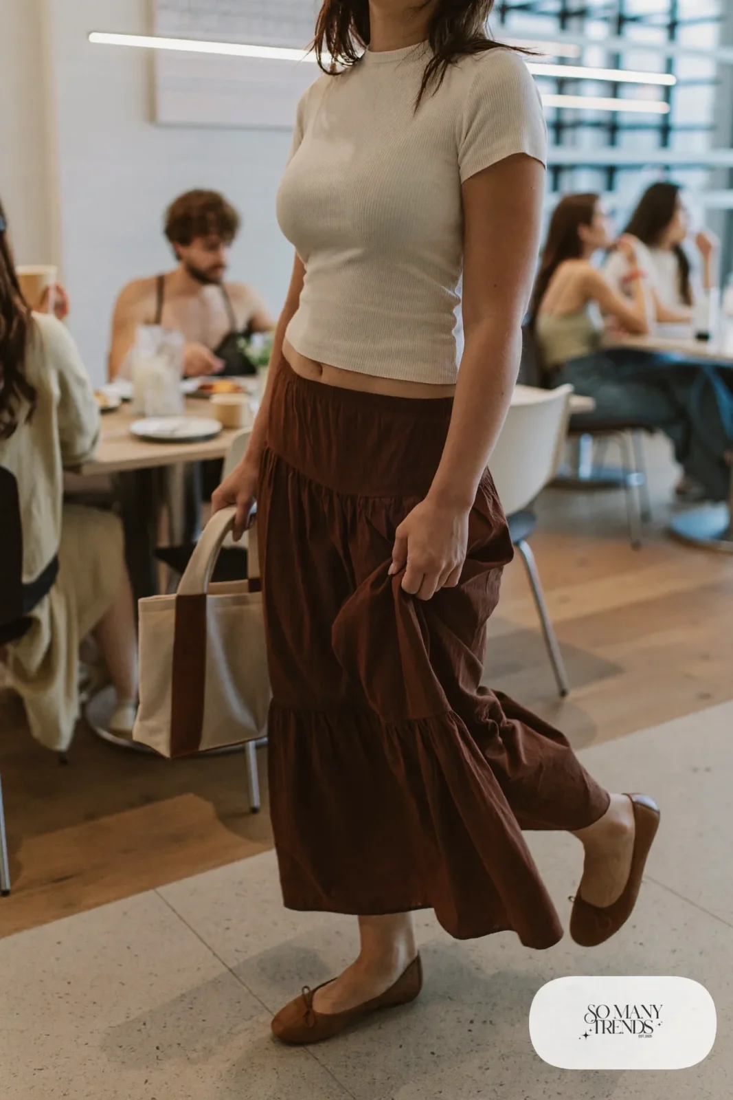 Chocolate brown tiered maxi skirt with fitted cream ribbed knit top and brown leather flats, outfit 1