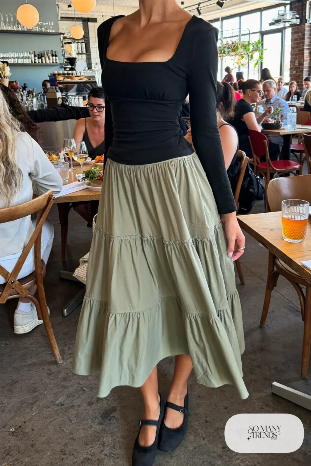 Sage green tiered midi skirt with fitted black long-sleeve square neck top and black mary janes, outfit 3