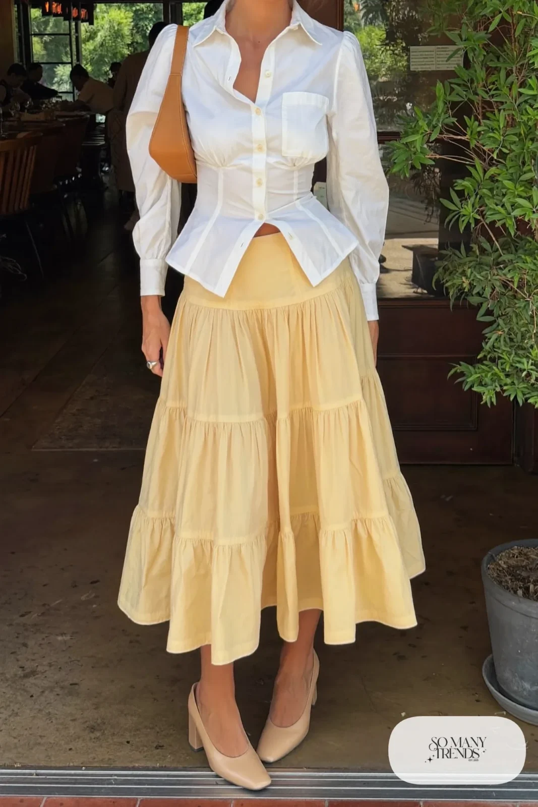 Butter yellow tiered midi skirt with fitted white collared blouse tucked in and nude block heels, outfit 9