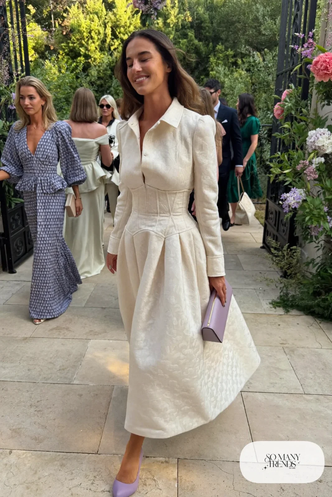 Woman in an ivory jacquard corset midi dress with long sleeves, lilac clutch and heels, outfit 7