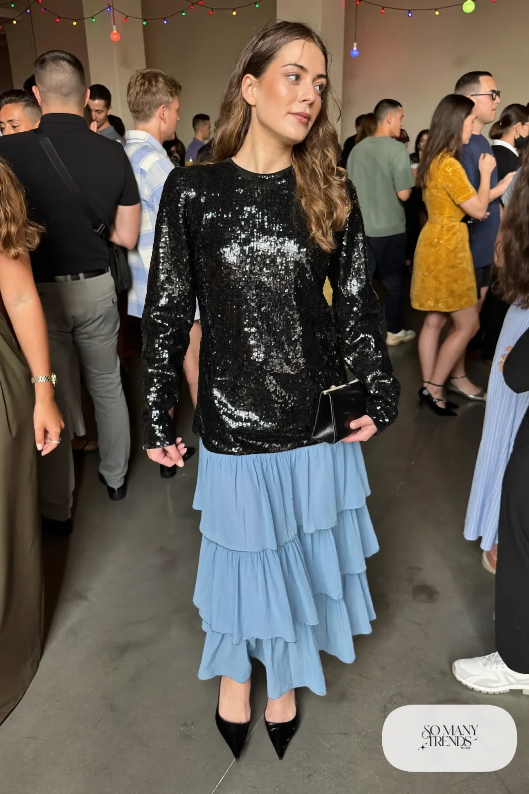 Powder blue tiered midi skirt with fitted black sequin long-sleeve top and black pointed pumps, outfit 25