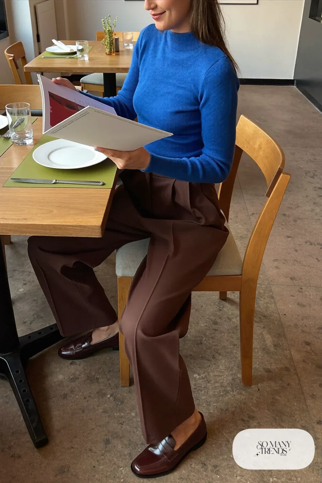 Fitted cobalt blue knit sweater tucked into high-waist chocolate brown wide-leg pants with brown loafers, outfit 19