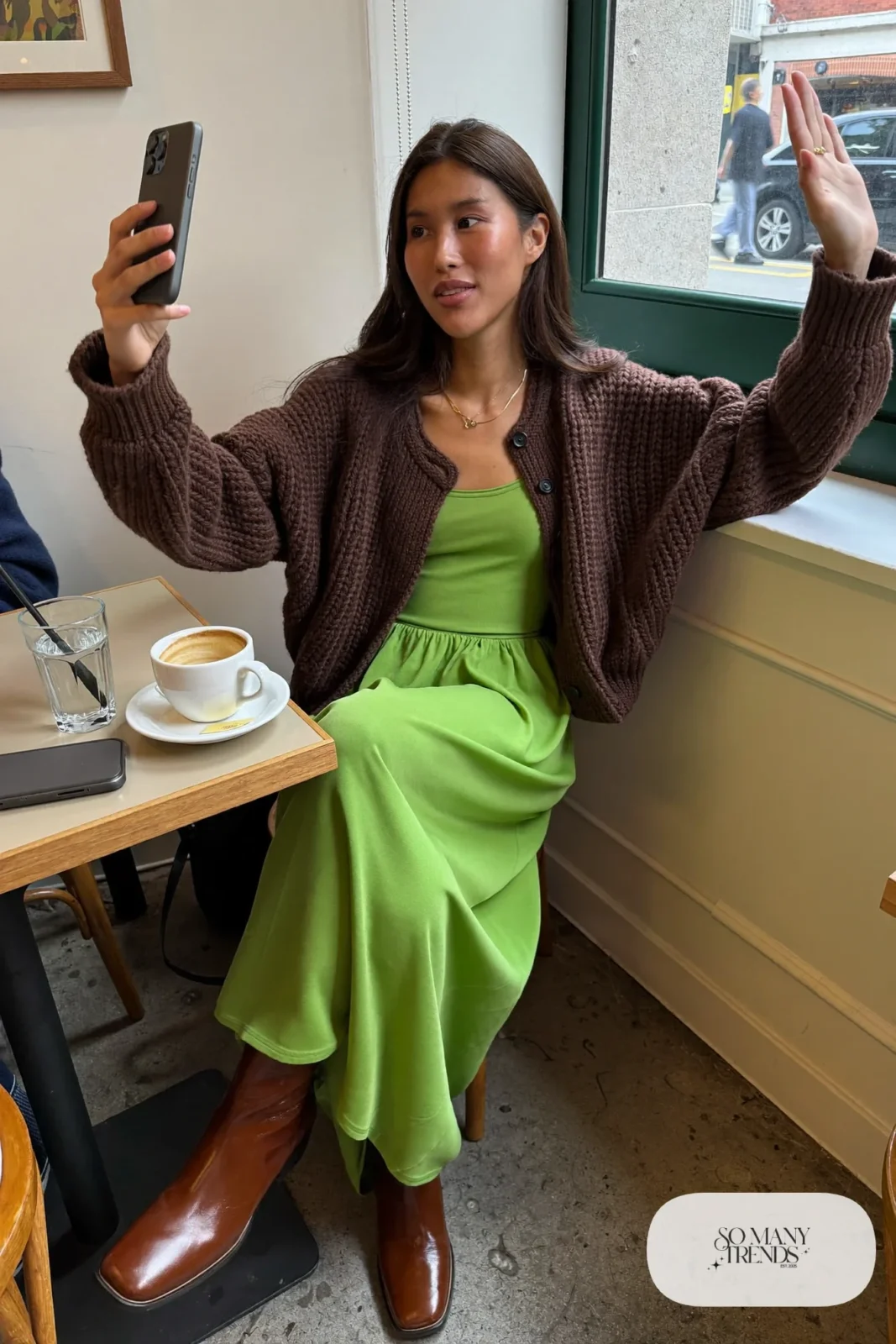 Chocolate brown knit cardigan over a grass green matte midi dress with brown leather boots, outfit 26