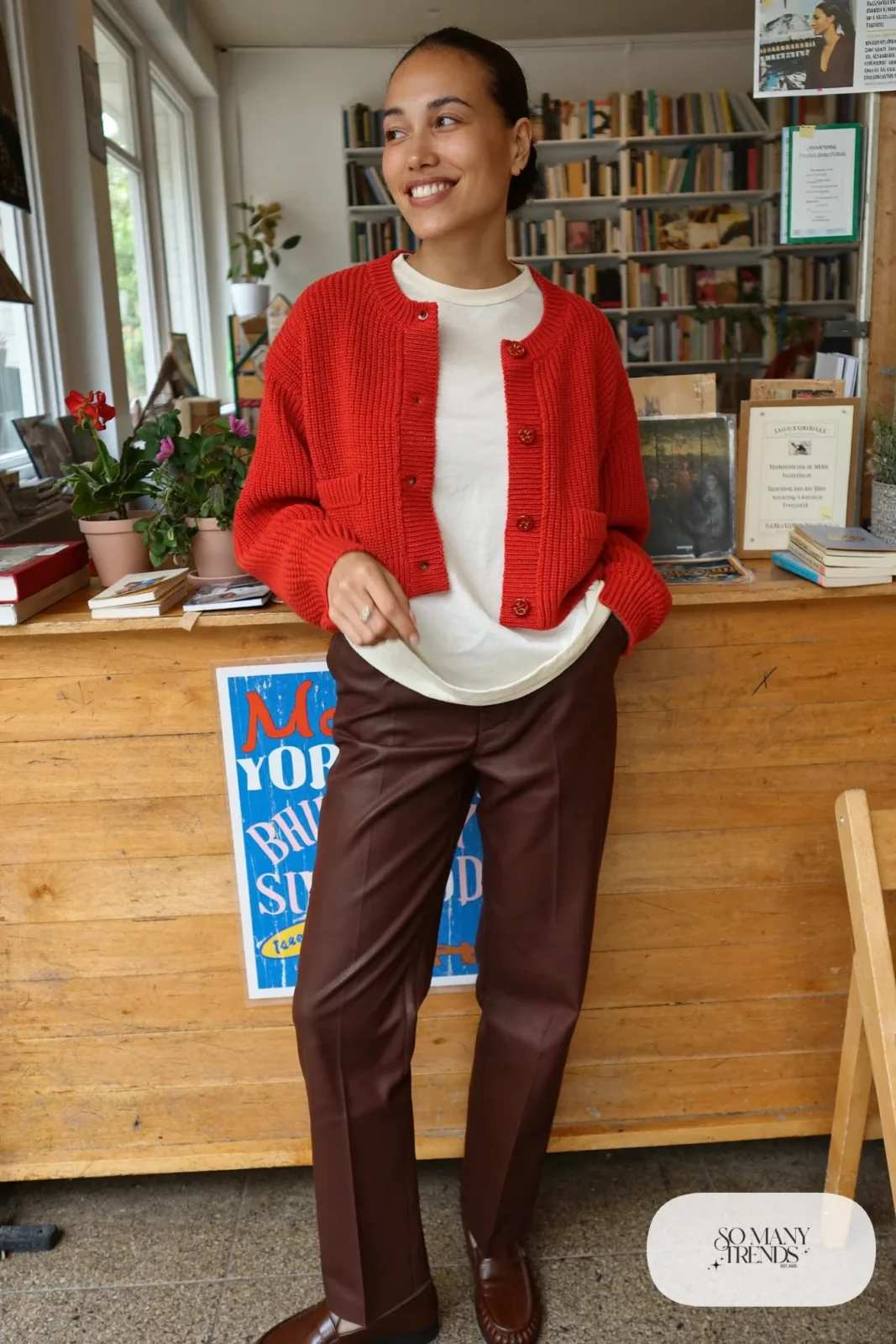 Boxy tomato red knit cardigan over a cream tee with straight chocolate brown pants and brown loafers, outfit 29