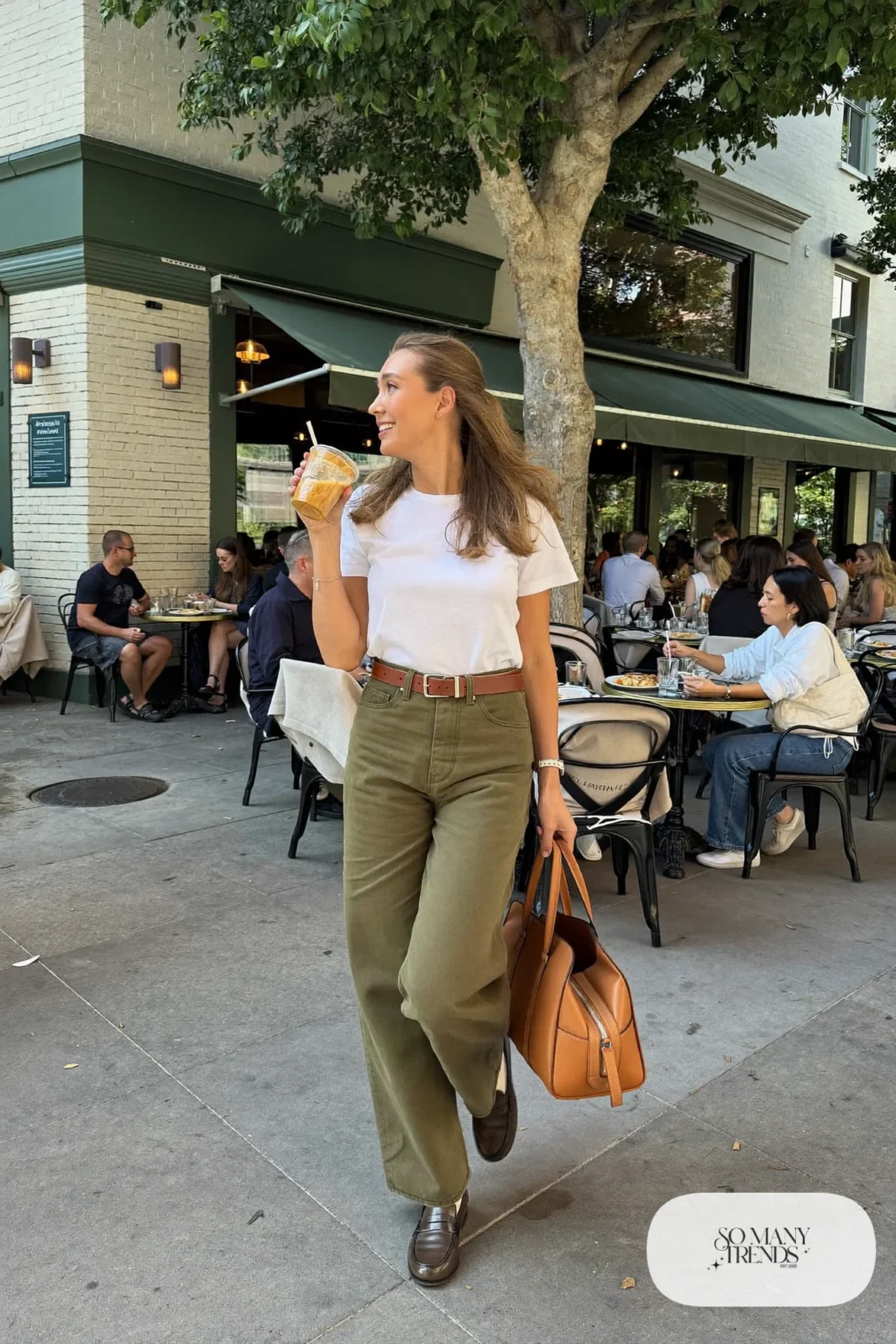 Woman in a white tee tucked into olive pants with a cognac belt and brown loafers, outfit 17