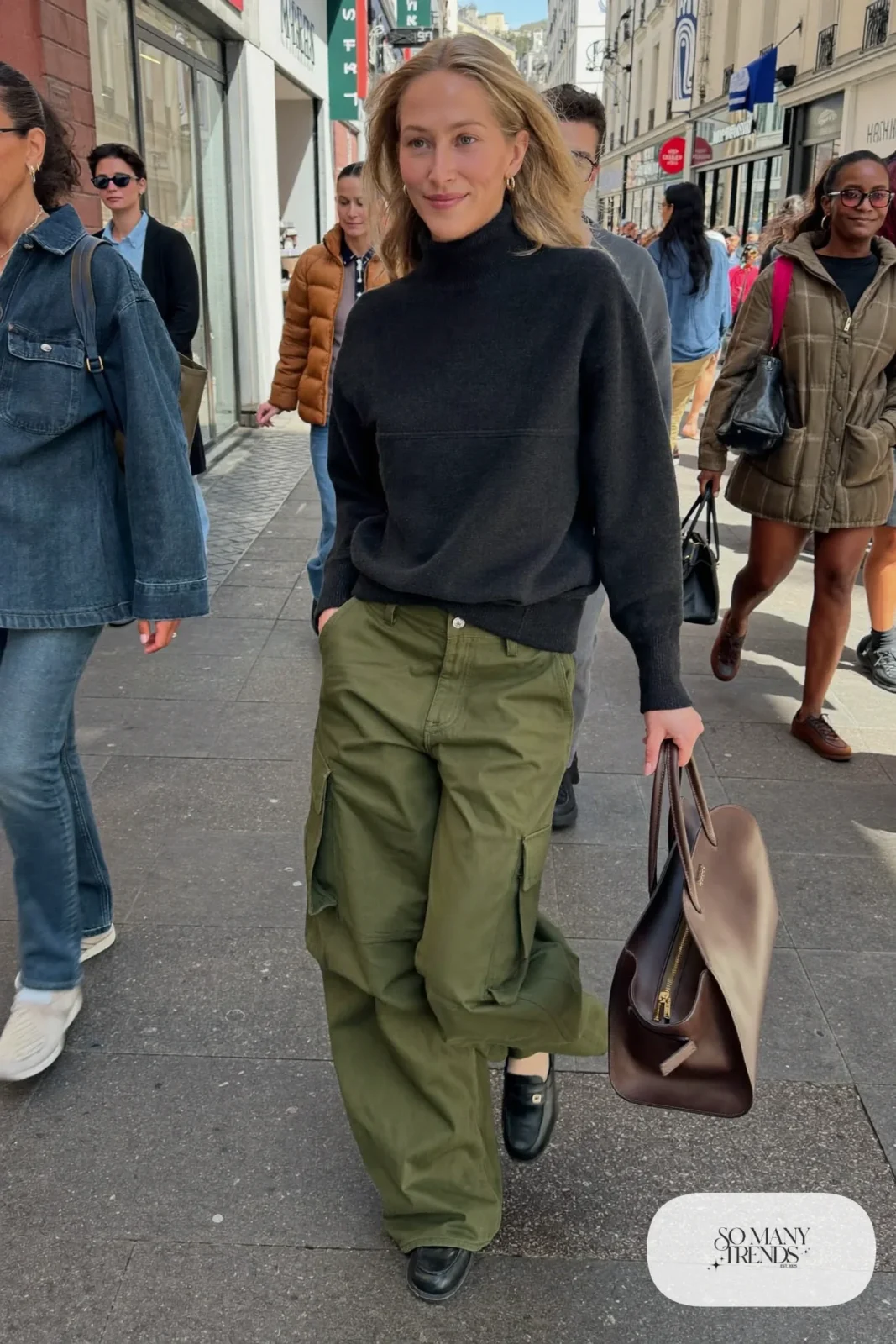 Woman in a black cashmere-blend sweater, olive cargo pants and black loafers, outfit 24