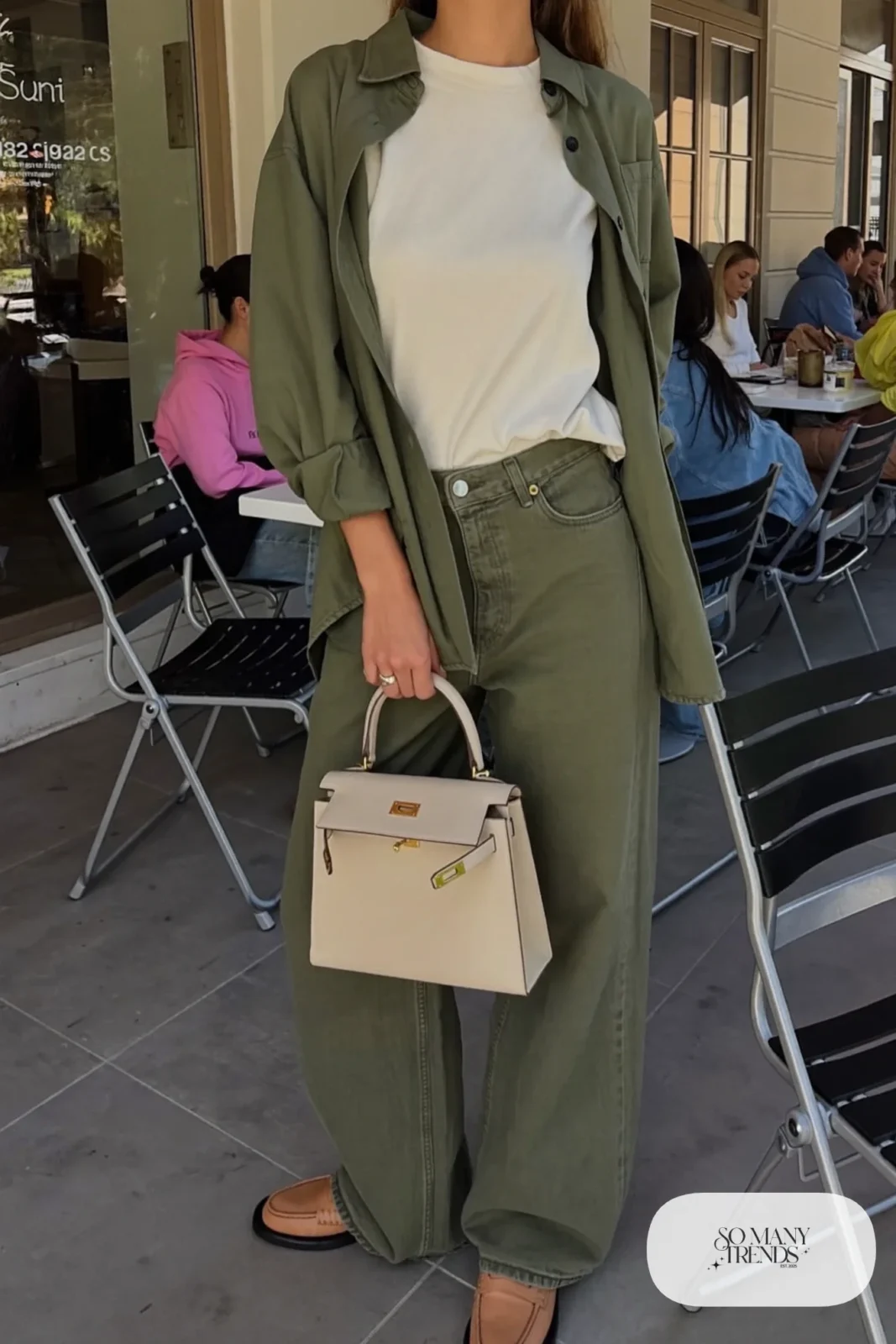 Woman in an olive matching shirt and pants set over a cream tee with tan loafers, outfit 29