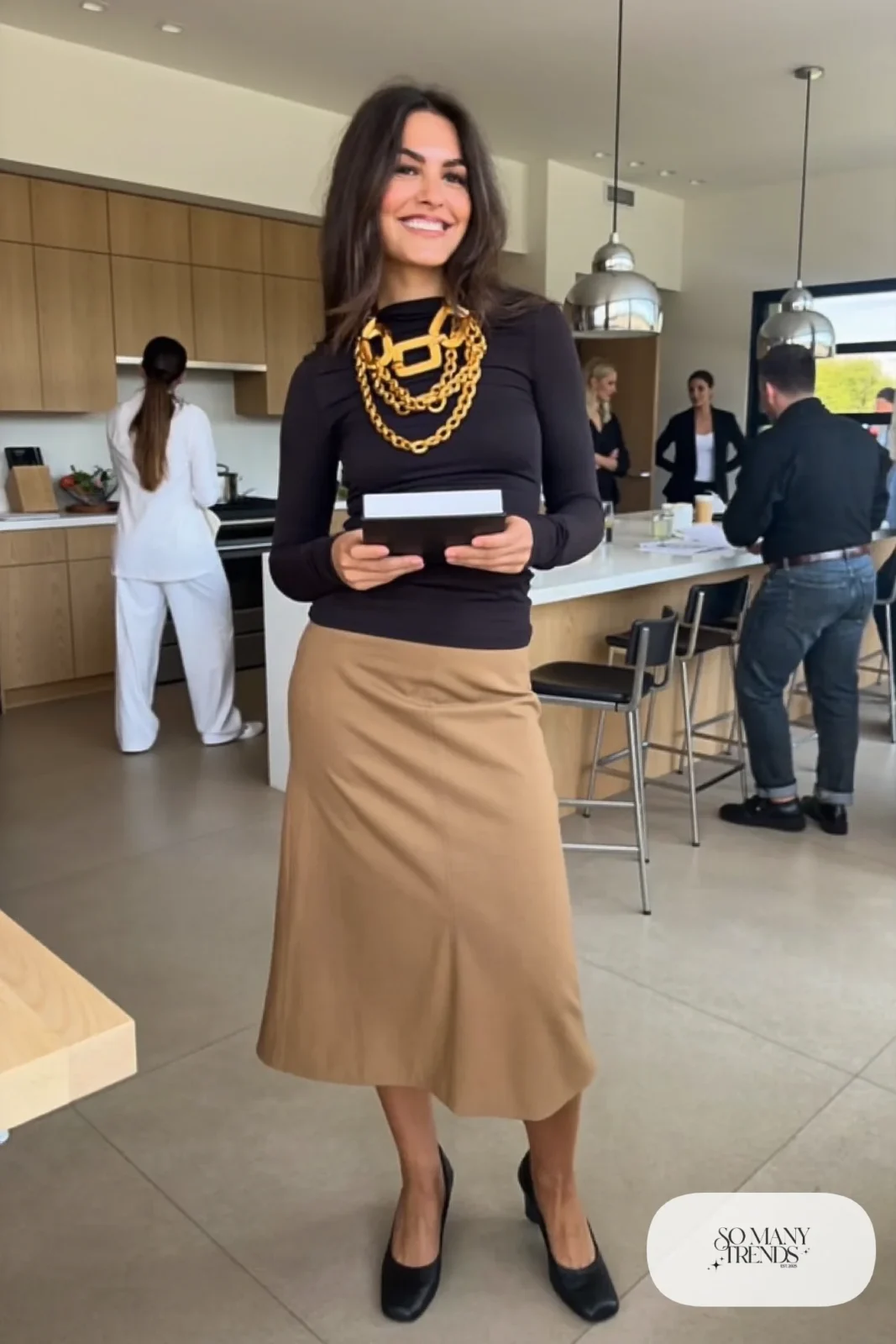 Woman in a black fitted top, camel pencil skirt with layered chunky chains and low pumps, outfit 16