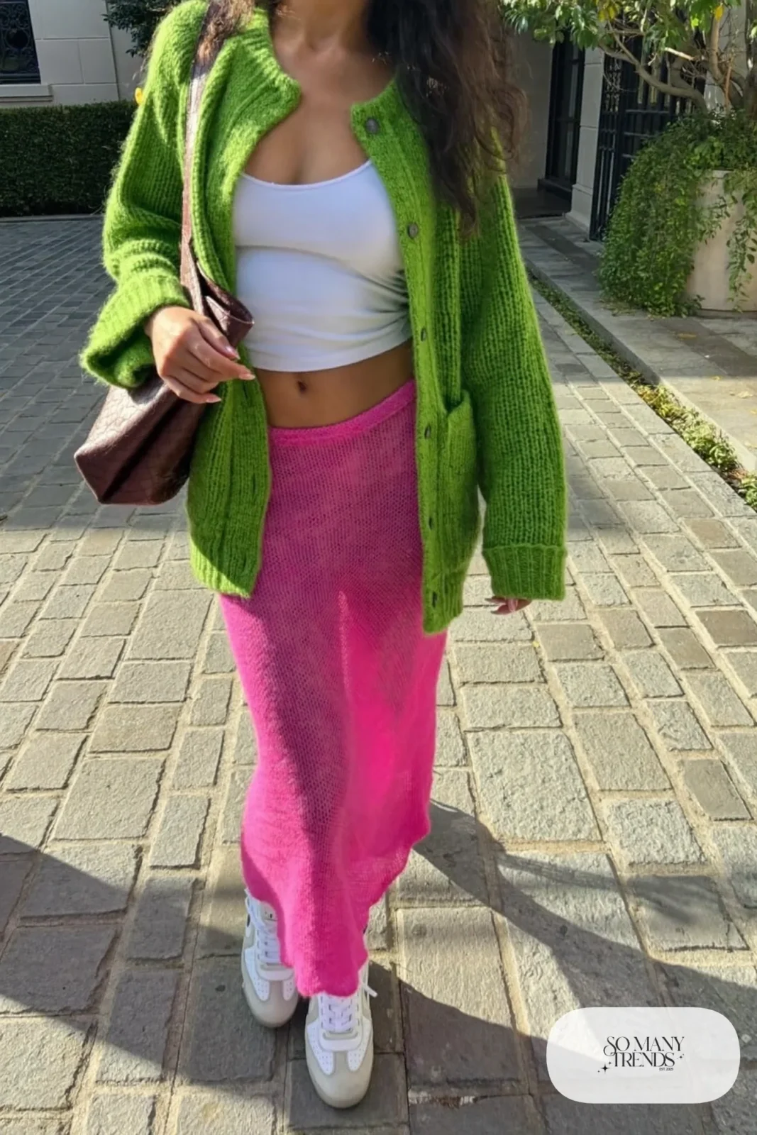 Grass green knit cardigan over a fitted white tank with a long hot pink knit skirt and white sneakers, outfit 23