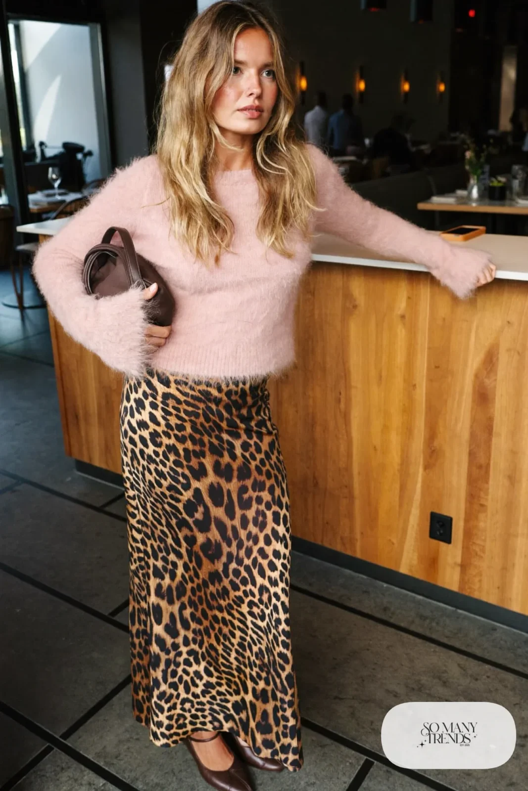 Woman in a soft pink mohair sweater, leopard print maxi skirt and chocolate brown closed-toe pumps, outfit 13