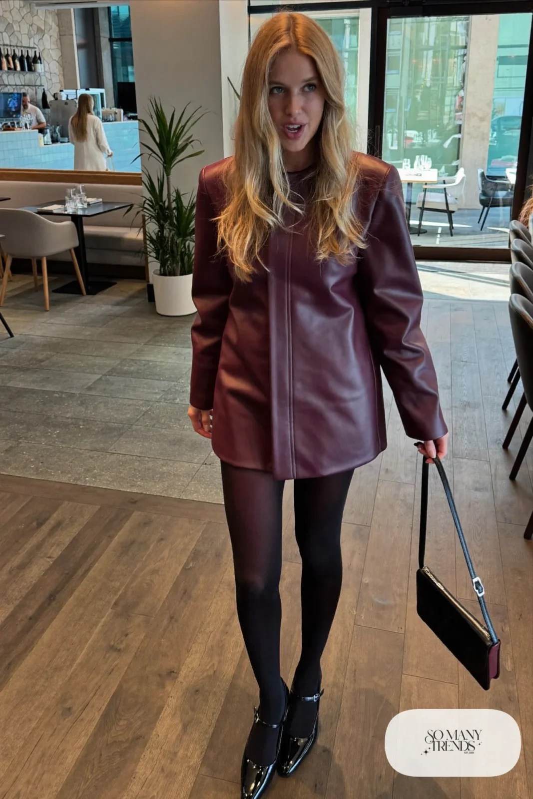 Woman in a long-sleeve plum mini dress, sheer tights and mary jane heels at a birthday dinner, outfit 15