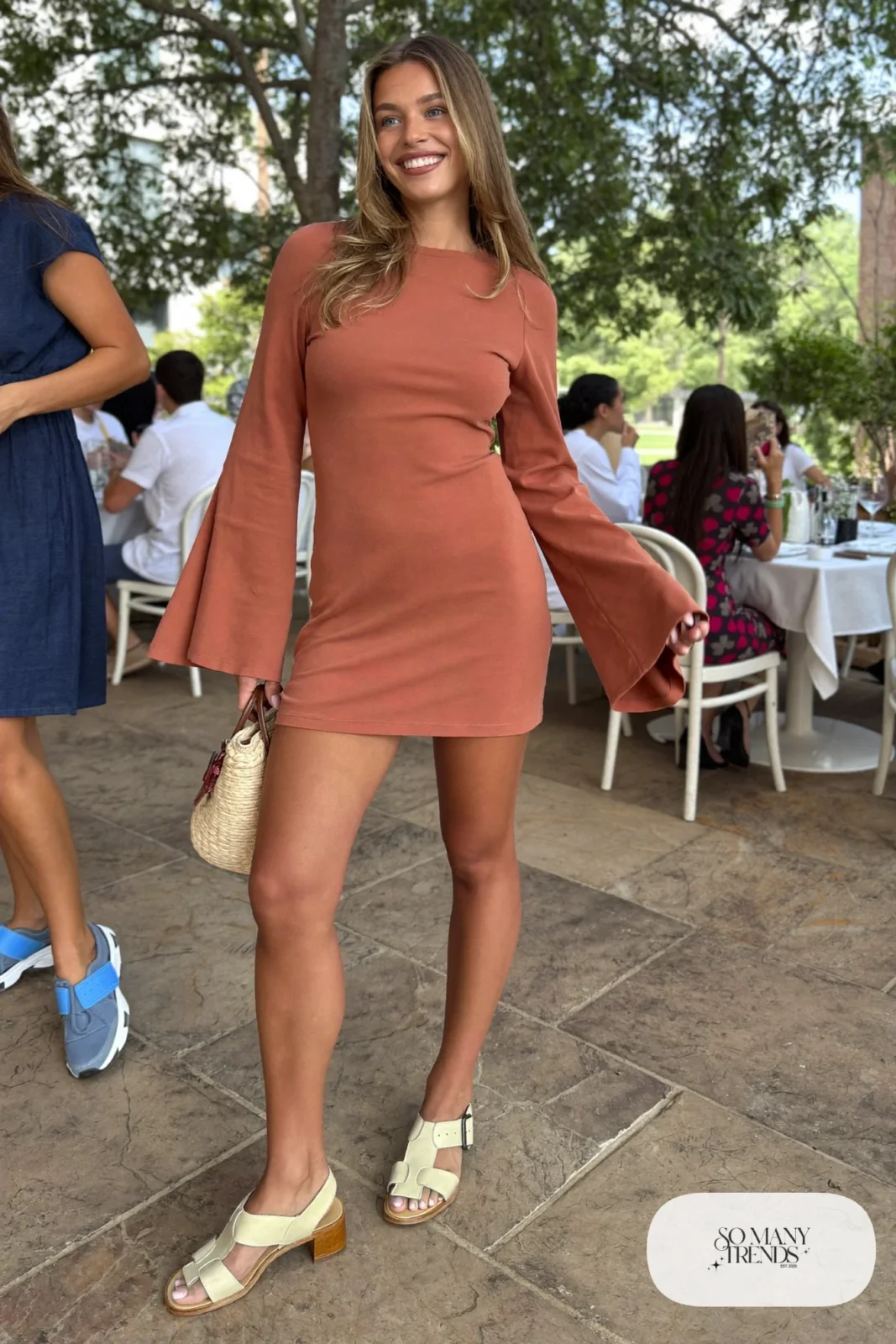 Look 11: terracotta bell sleeve mini dress with bare legs and cream leather sandals