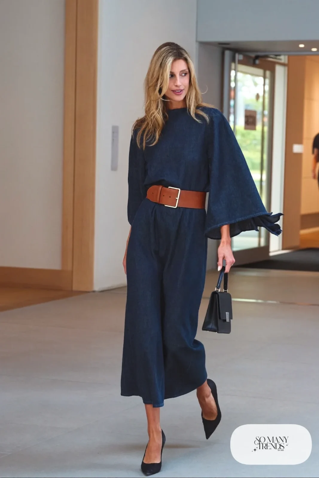 Look 13: indigo bell sleeve midi dress with a wide cognac leather belt and black pointed pumps