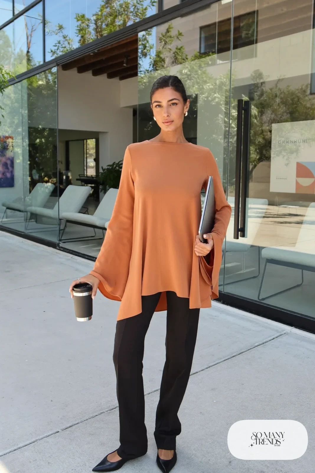 Look 24: terracotta bell sleeve top, black straight-leg pants and black pointed-toe flats