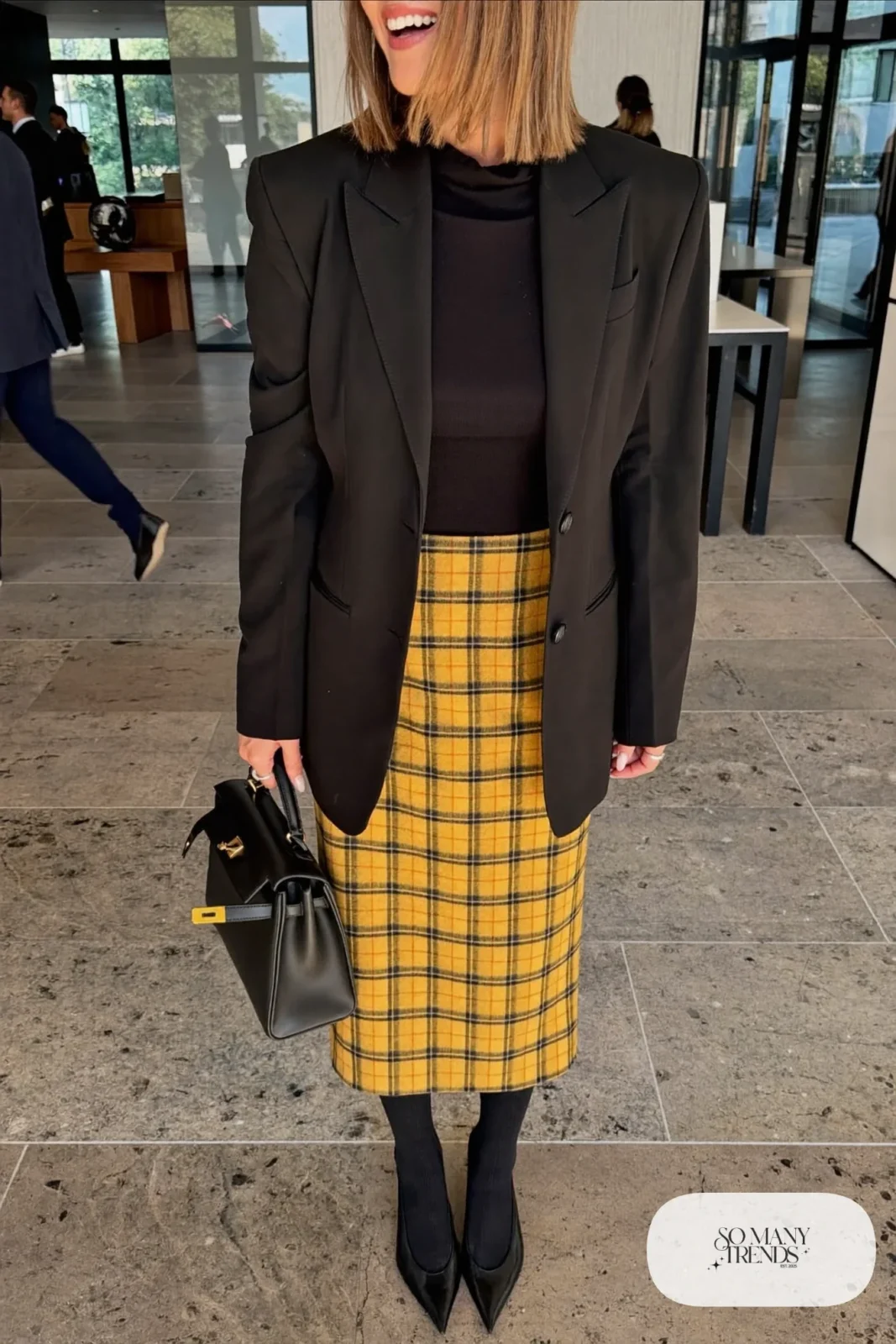 Mustard plaid midi skirt with black relaxed blazer, black knit top, sheer tights and black pointed pumps, outfit 12