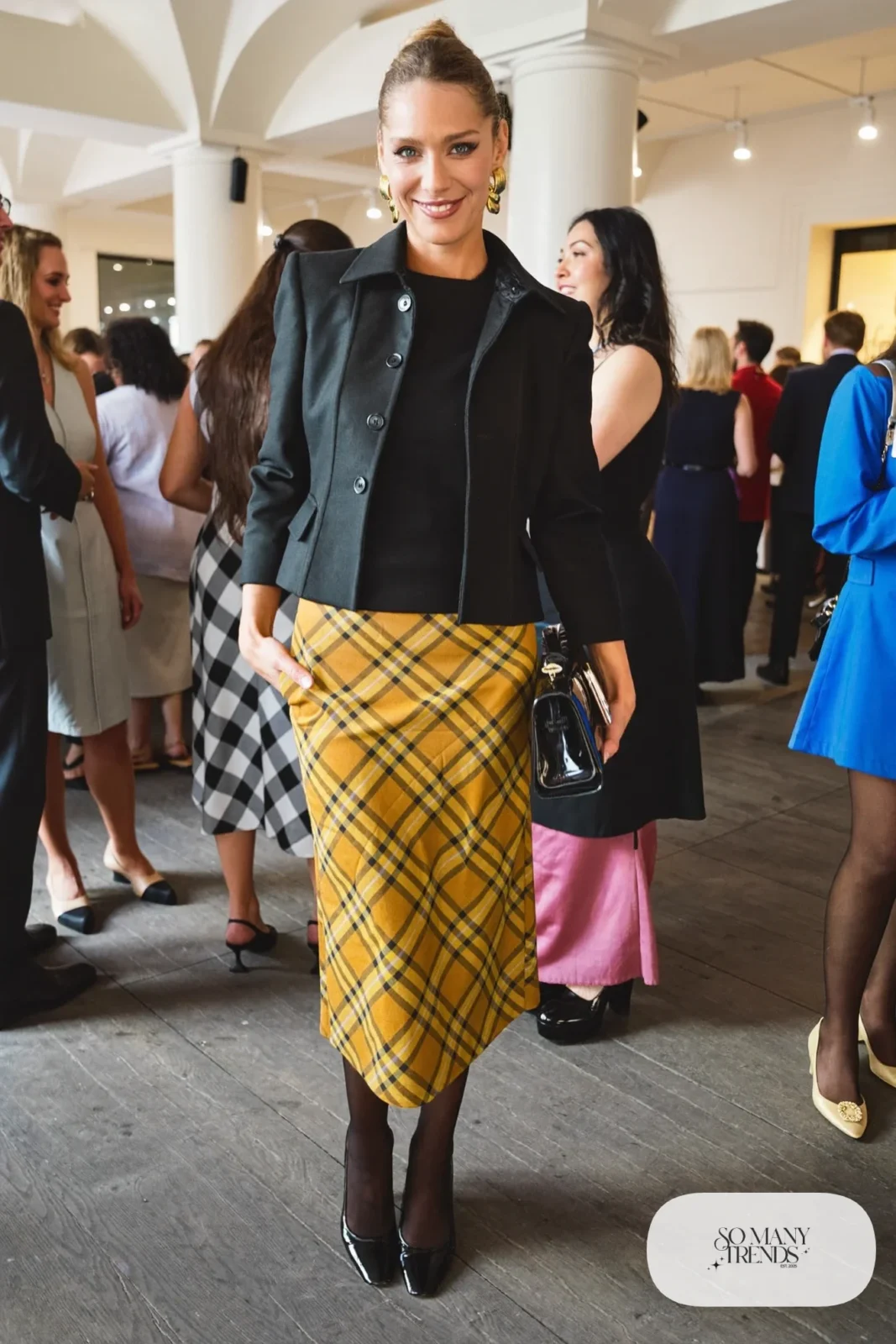 Mustard plaid midi skirt with black knit top, short black jacket, sheer tights and black pumps, outfit 23