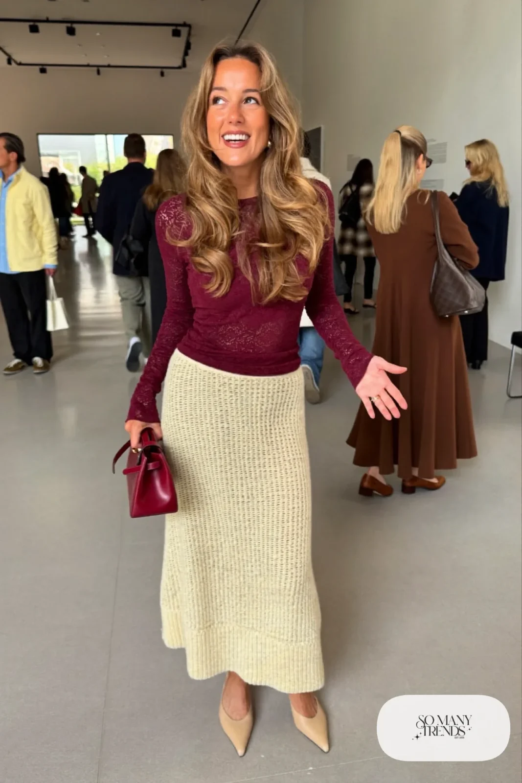 Burgundy long-sleeve lace top with an ecru column midi skirt, nude mules and a small structured bag, look 16