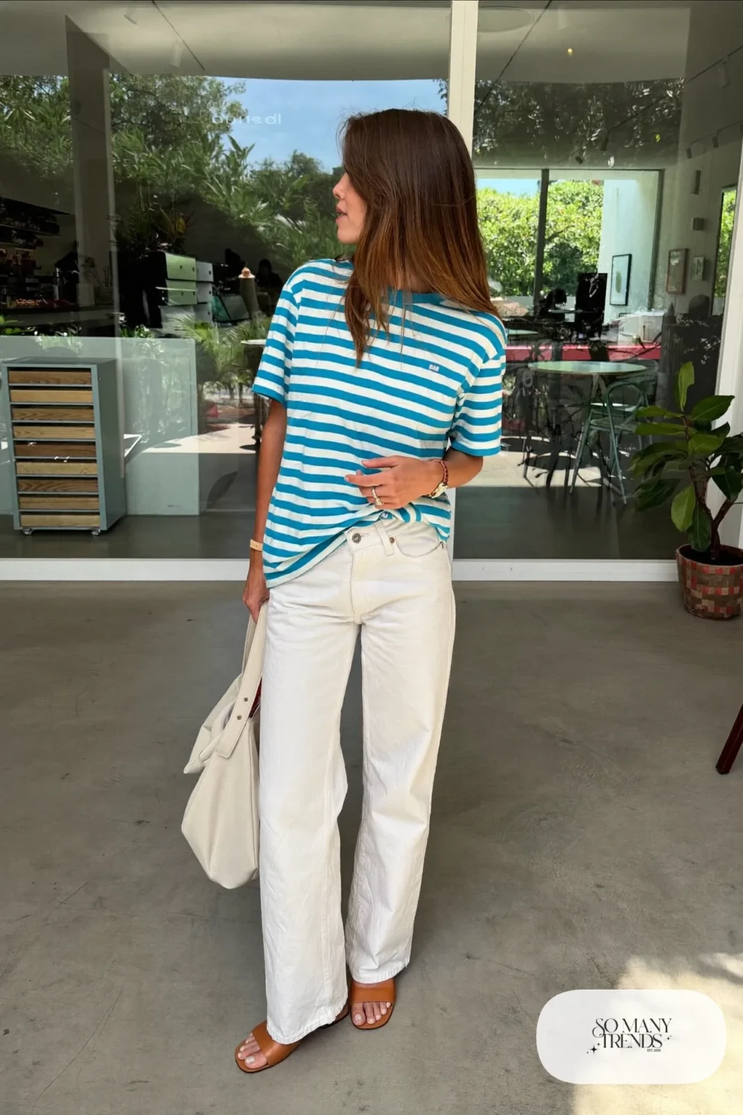 Woman in a turquoise and white striped tee, white straight jeans and tan sandals, outfit 21