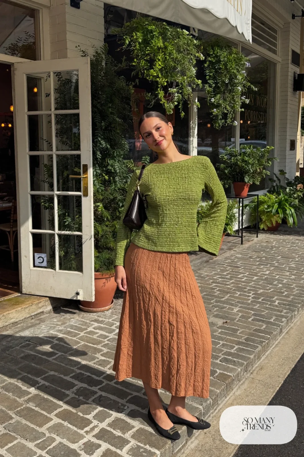 Look 8: olive bell sleeve top tucked into a terracotta pleated midi skirt with black ballet flats