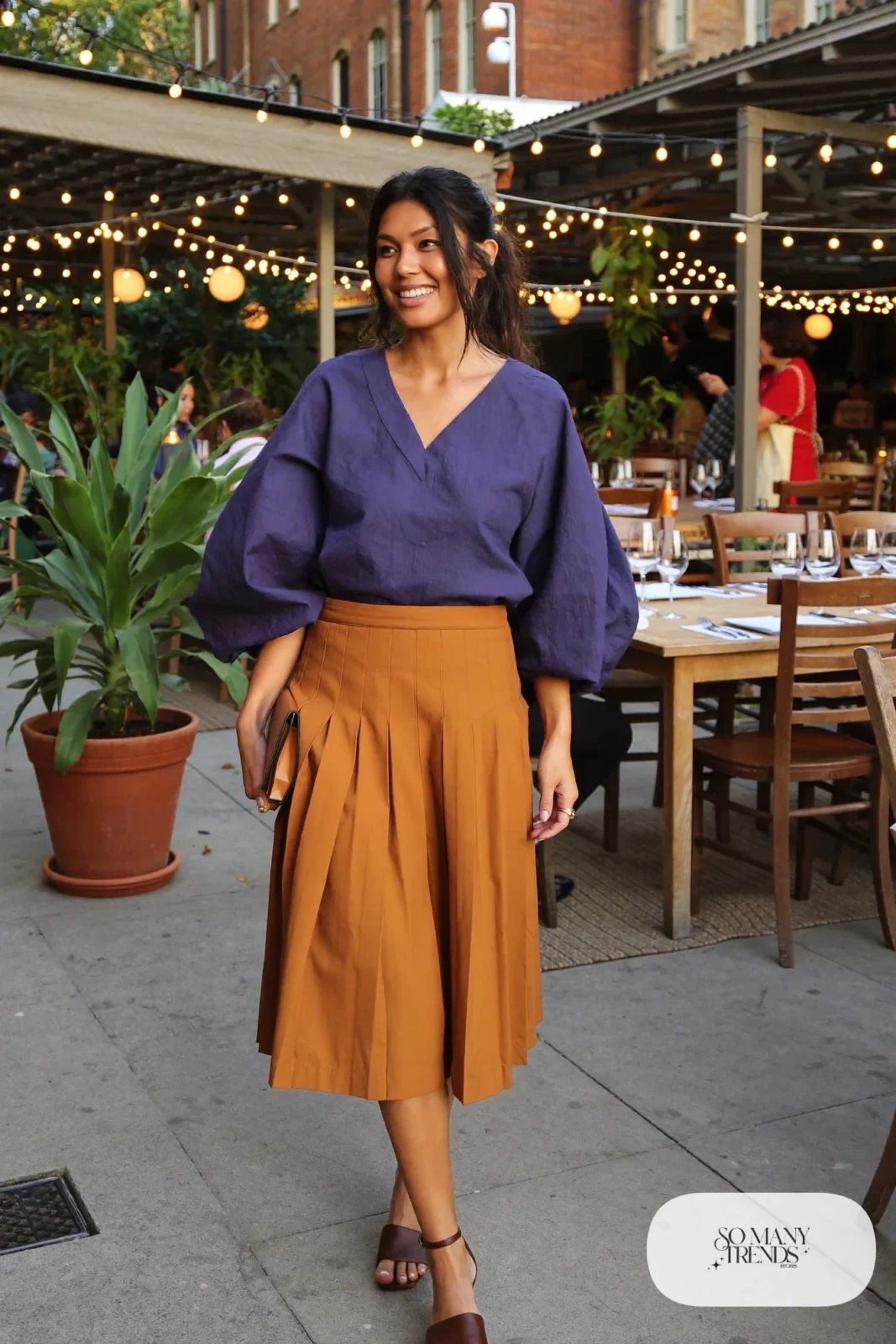 Look 23: indigo bell sleeve top, mustard pleated midi skirt and brown leather ankle-strap sandals