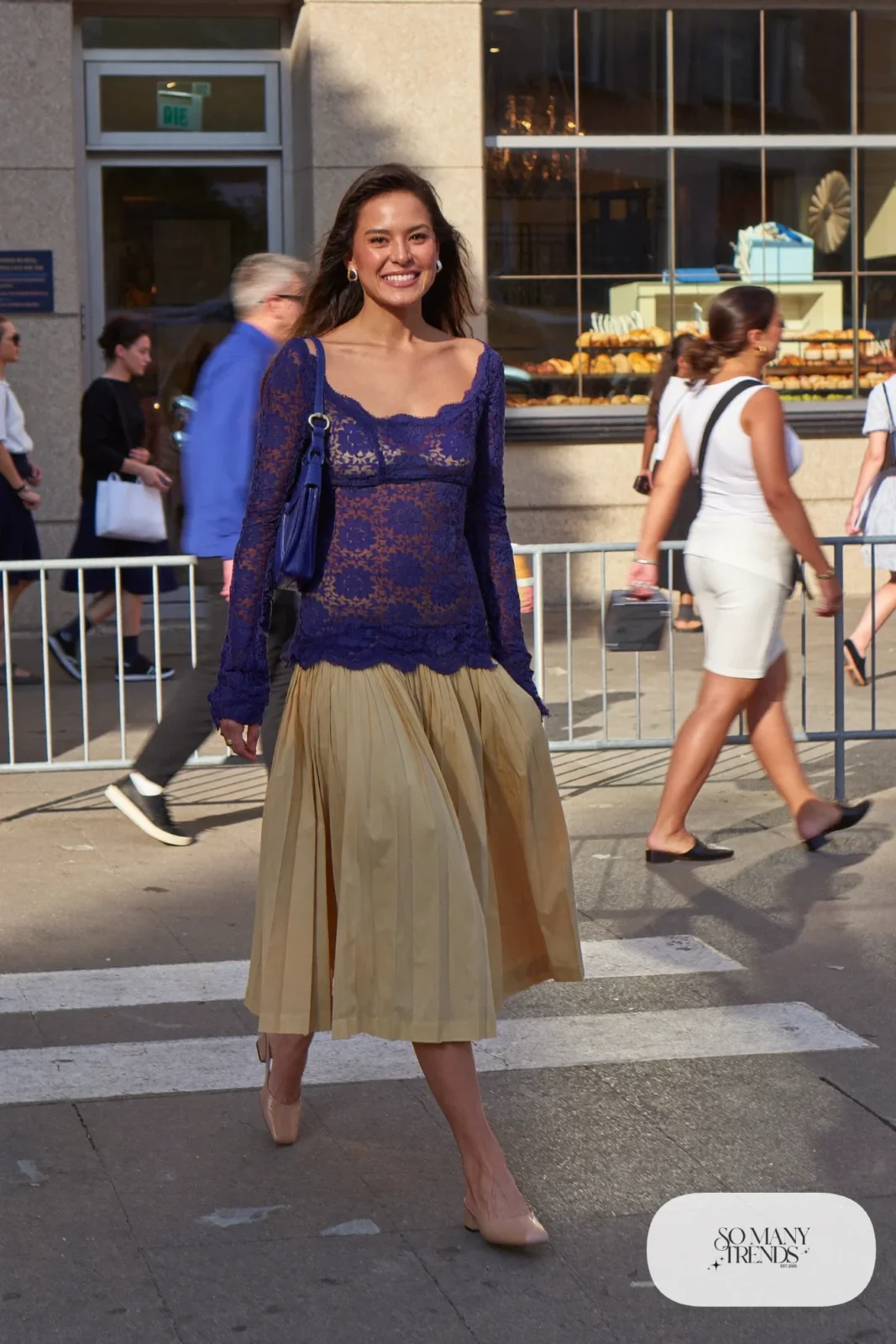 Navy long-sleeve lace top with a butter yellow pleated midi skirt, nude block heel pumps and a small bag, look 14