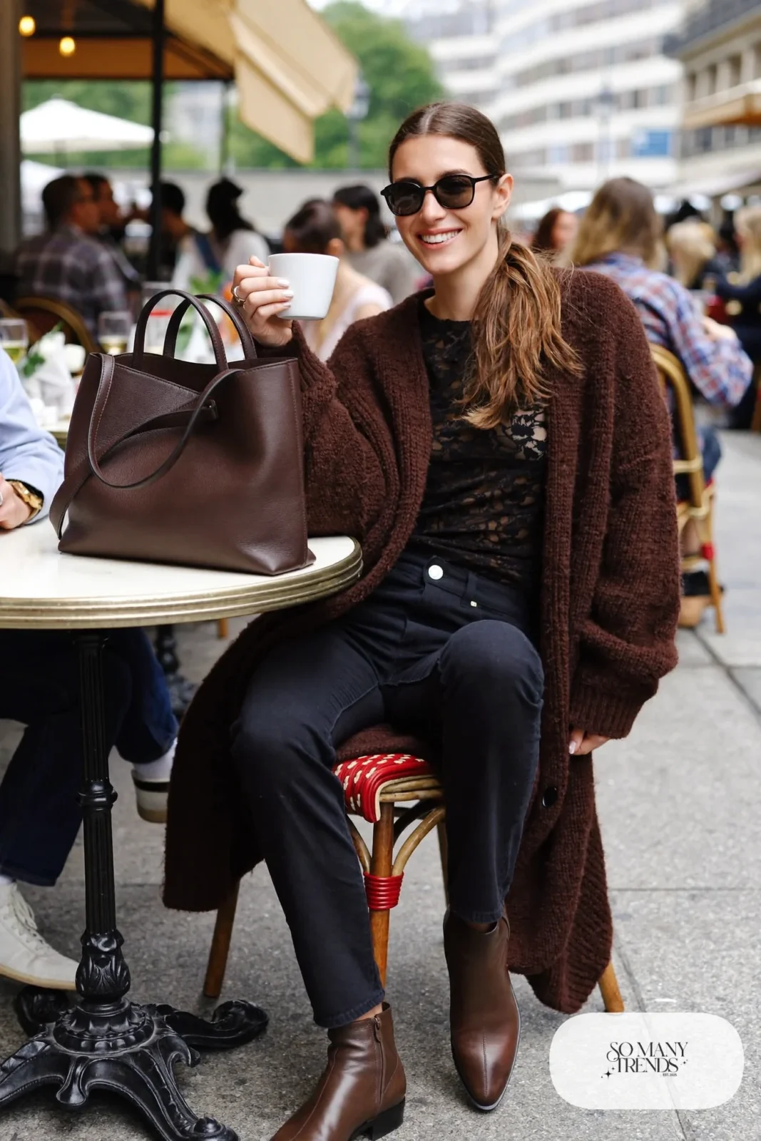 Black lace top under an oversized chocolate brown knit cardigan with straight jeans and brown boots, look 18