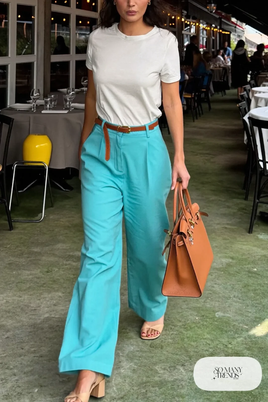Woman in turquoise wide-leg pants, a fitted white tee, tan belt and nude heeled sandals, outfit 8