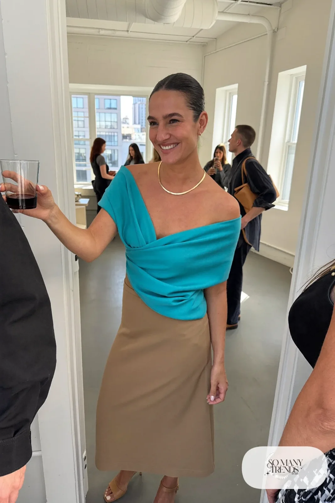 Woman in a turquoise off-shoulder top, tan midi skirt and tan heeled sandals with bare legs, outfit 19