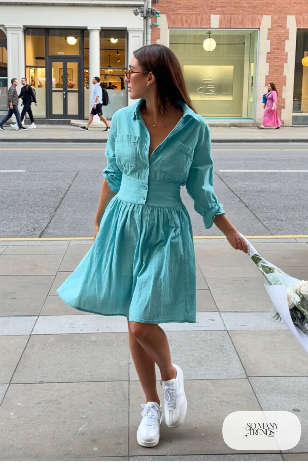 Woman in a turquoise chambray shirt dress, brown belt and white sneakers, outfit 23