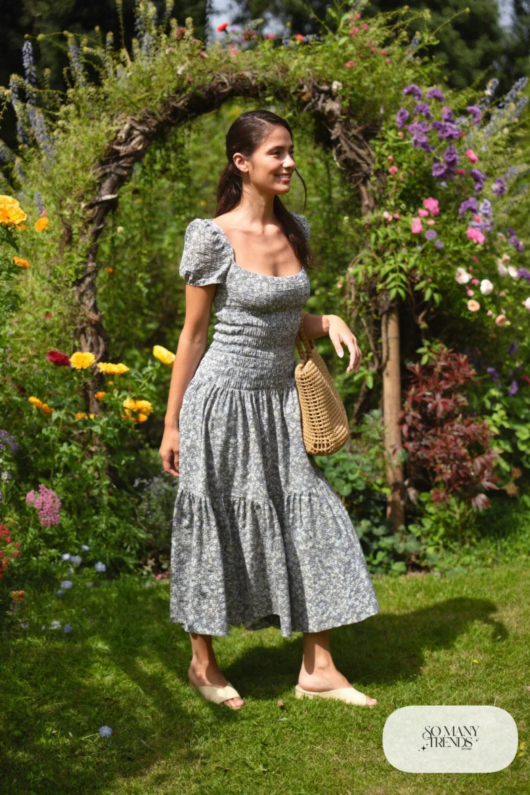 Woman in a slate blue and cream floral cotton midi dress with puff sleeves and cream block-heel sandals, garden party outfit 8
