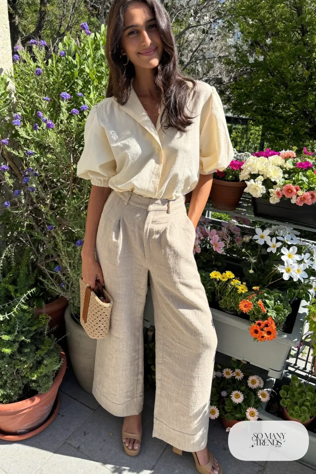 Woman in wide-leg cream linen pants with a soft blouse and block-heel sandals, garden party outfit 19