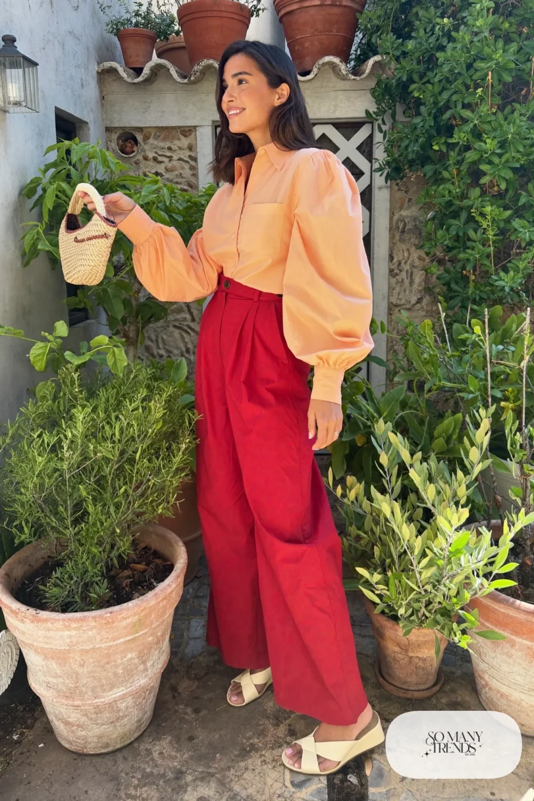 Woman in a peach cotton blouse and wine wide-leg pants with cream wedge sandals, garden party outfit 21