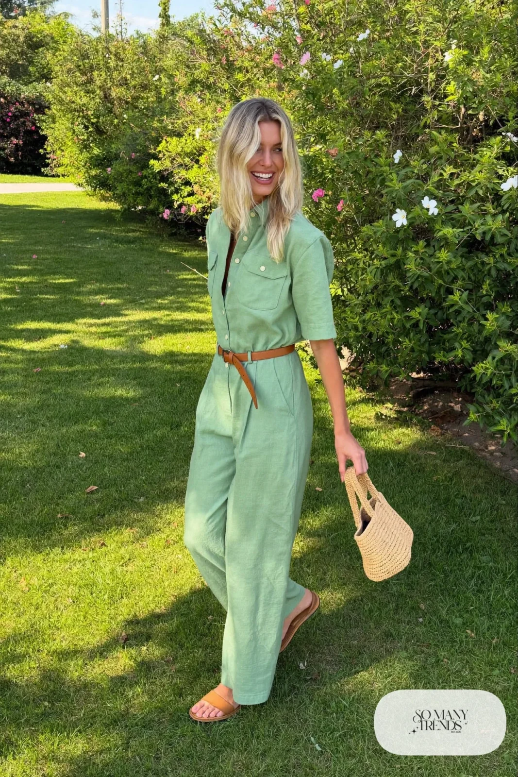 Woman in a mint linen wide-leg jumpsuit with a tan belt and flat sandals, garden party outfit 22