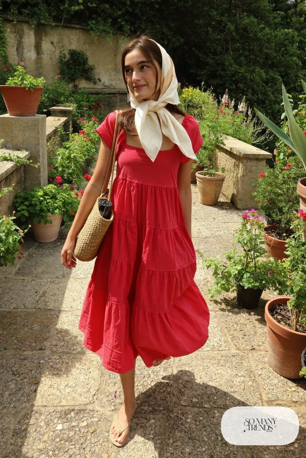 Woman in a red tiered cotton midi dress with a cream silk hair scarf and flat sandals, garden party outfit 27