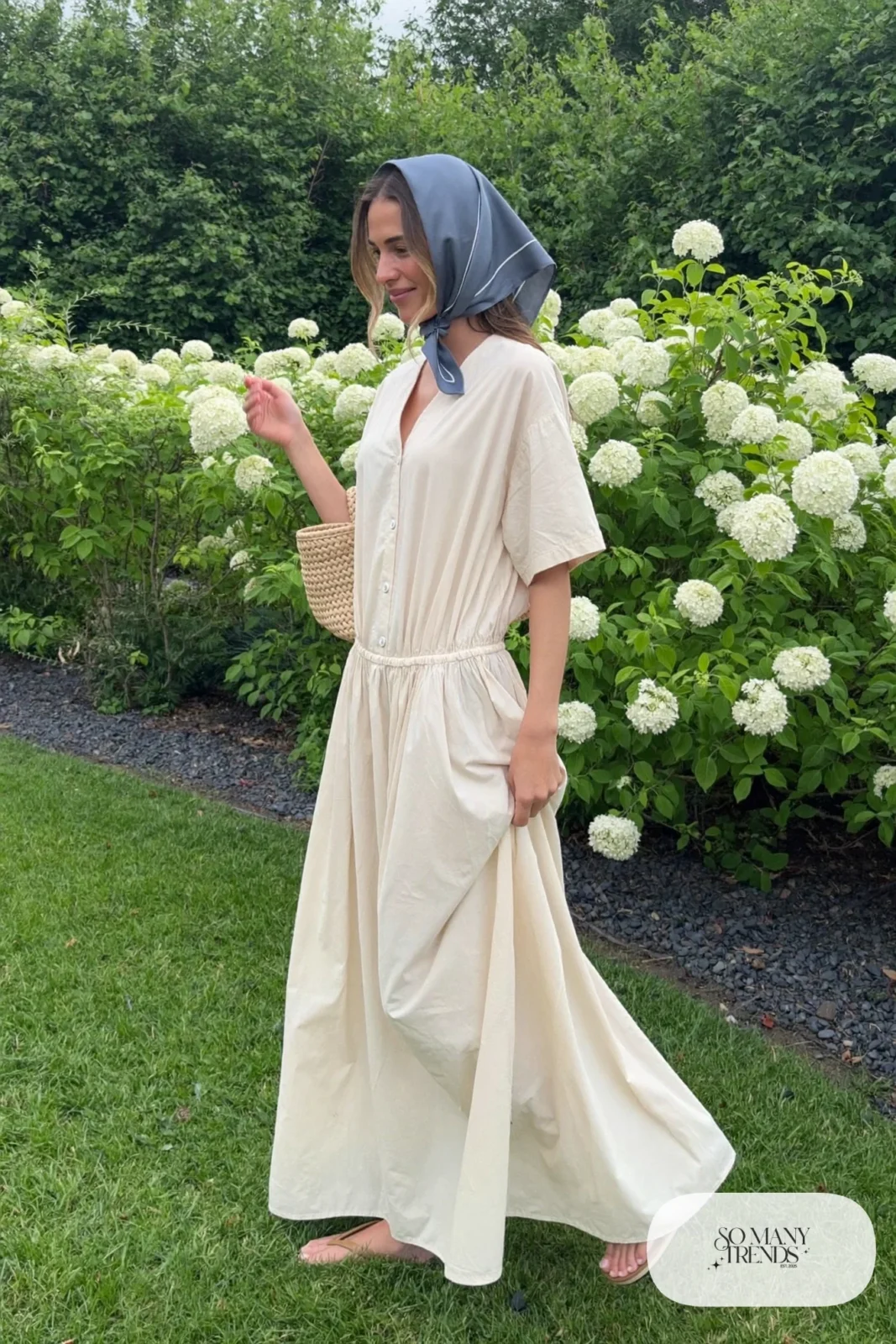 Woman in a cream cotton maxi dress with slate blue silk scarf in her hair and tan flat sandals, garden party outfit 7