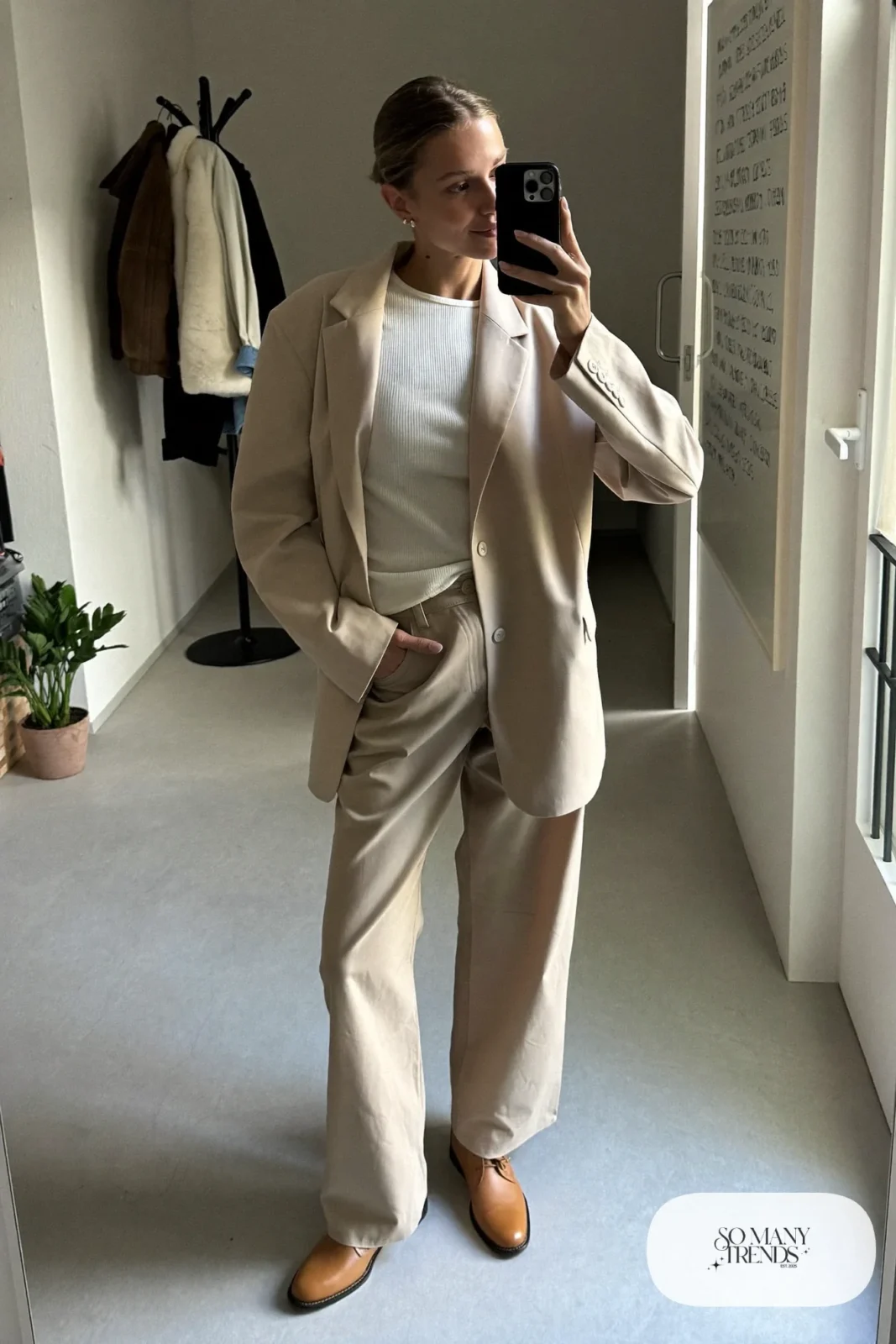 Beige relaxed blazer, beige straight pants, ivory knit top and tan derby shoes in a mirror selfie, outfit 4