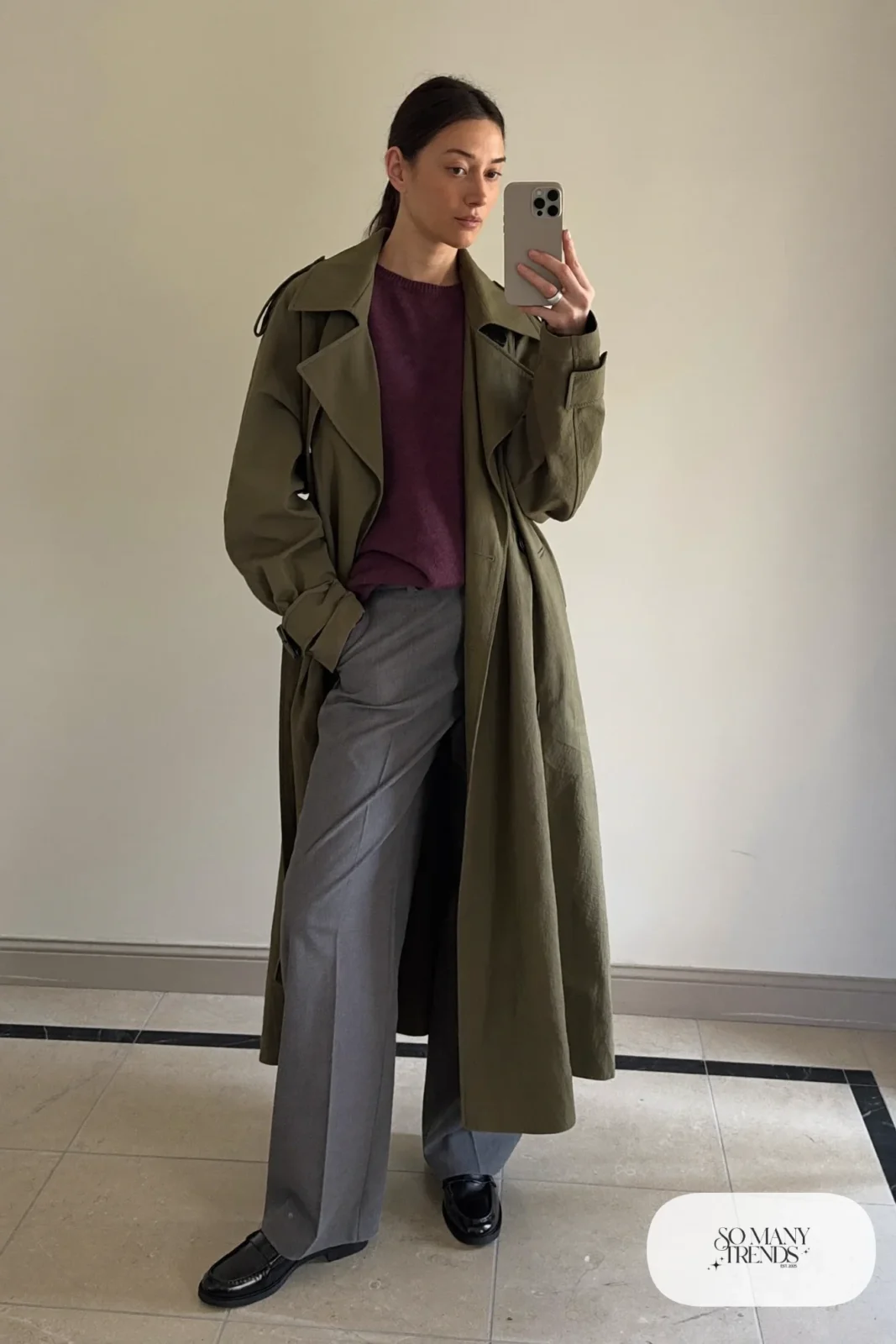 Olive trench coat, plum knit sweater, gray straight pants and loafers in a mirror selfie, outfit 8