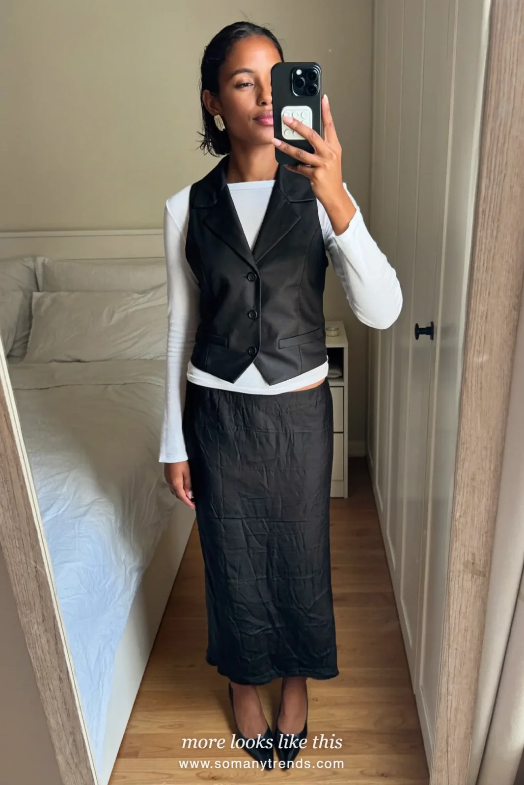 Black tailored vest over white fitted top with champagne silk midi skirt and heels, outfit 8